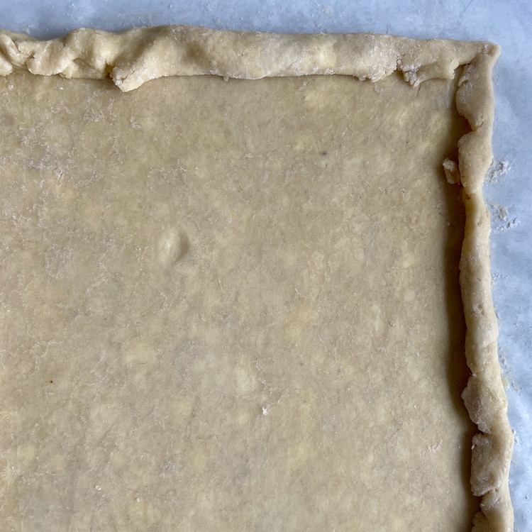 Image of Fold each of the sides in by half an inch and give it a gentle press to flatten.